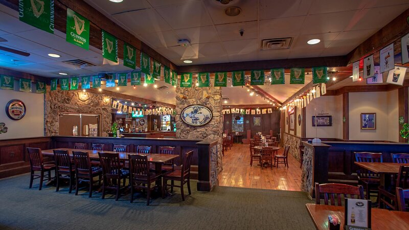 Dining room with multiple tables and banner that says Guinness